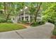 Elegant home featuring a long driveway, manicured lawn, and a charming two-story design at 400 Old Ivy Ne Rd, Atlanta, GA 30342