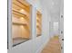 Bright hallway featuring built-in storage cabinets, hardwood floors, and neutral paint at 400 Old Ivy Ne Rd, Atlanta, GA 30342