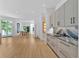 Bright, open kitchen features wood floors, black marble backsplash, and updated cabinets at 400 Old Ivy Ne Rd, Atlanta, GA 30342