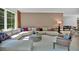 Bright, open living room with large sectional sofa, neutral decor, and natural light at 400 Old Ivy Ne Rd, Atlanta, GA 30342