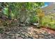 Secluded patio features stone walls and flagstone pavers surrounded by lush, mature landscaping at 400 Old Ivy Ne Rd, Atlanta, GA 30342