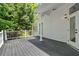 Porch with white railings and a view of the surrounding woods and the exterior of the house at 400 Old Ivy Ne Rd, Atlanta, GA 30342