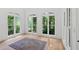 Bright sun room with hardwood floors and lots of windows with wooded views at 400 Old Ivy Ne Rd, Atlanta, GA 30342