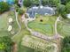 Aerial view highlighting the golf course and clubhouse amidst lush greenery at 5844 Brookstone Nw Walk, Acworth, GA 30101