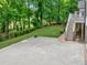 The backyard is well manicured with green grass and landscaping, stairs and brick pavers at 5844 Brookstone Nw Walk, Acworth, GA 30101