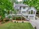 Beautiful backyard view of white two-story home with an inviting deck and well-manicured lawn at 5844 Brookstone Nw Walk, Acworth, GA 30101