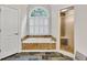 Bright bathroom features a soaking tub with stone surround, walk-in shower, and stone floors at 5844 Brookstone Nw Walk, Acworth, GA 30101