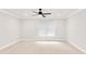Neutral bedroom with carpet, white walls, a ceiling fan, and a large window at 5844 Brookstone Nw Walk, Acworth, GA 30101