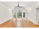 Airy primary bedroom featuring hardwood floors, tray ceiling, large windows and backyard view at 5844 Brookstone Nw Walk, Acworth, GA 30101
