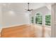 Spacious bedroom with hardwood floors, tray ceiling, and large windows offering backyard views at 5844 Brookstone Nw Walk, Acworth, GA 30101