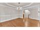 Spacious dining room featuring hardwood floors, a tray ceiling, and modern light fixture at 5844 Brookstone Nw Walk, Acworth, GA 30101