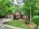 Attractive brick home with a two-car garage, lush green lawn, and mature trees for added privacy at 5844 Brookstone Nw Walk, Acworth, GA 30101