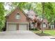 Beautiful brick home features a two-car garage, mature trees, and a well-manicured lawn at 5844 Brookstone Nw Walk, Acworth, GA 30101