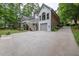 Back of house with private garage and driveway, enhanced by a lush green lawn at 5844 Brookstone Nw Walk, Acworth, GA 30101