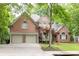 Lovely brick home with a two-car garage, well-maintained lawn, and mature trees surrounding the property at 5844 Brookstone Nw Walk, Acworth, GA 30101