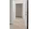 Neutral carpeted hallway with white trim and an open doorway at 5844 Brookstone Nw Walk, Acworth, GA 30101