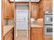 View into walk-in pantry from the kitchen, featuring extensive shelving and cabinet space at 5844 Brookstone Nw Walk, Acworth, GA 30101