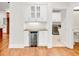 Wet bar with wine fridge, display cabinets and granite countertops located near laundry and bathroom at 5844 Brookstone Nw Walk, Acworth, GA 30101