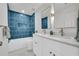 Stylish bathroom with a double sink vanity and elegant blue tiled shower at 1 N Boundary Nw Pl, Atlanta, GA 30318