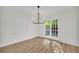 Bright dining room with modern light fixture and doors leading to outside at 1 N Boundary Nw Pl, Atlanta, GA 30318
