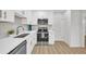 Modern white kitchen with stainless steel appliances and quartz countertops at 1 N Boundary Nw Pl, Atlanta, GA 30318