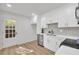 Bright, updated kitchen with white cabinets, stainless appliances, and a door to the outside at 1 N Boundary Nw Pl, Atlanta, GA 30318