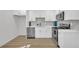 Modern kitchen features white cabinets, stainless steel appliances, and stylish tile backsplash at 1 N Boundary Nw Pl, Atlanta, GA 30318