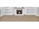Bright living room with wood flooring, a fireplace, and built-in shelving at 1 N Boundary Nw Pl, Atlanta, GA 30318