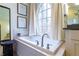 Elegant bathroom featuring a soaking tub with a view, stylish fixtures, and decor at 2067 Telfair Circle # A&B, Atlanta, GA 30324