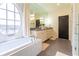 Modern bathroom featuring a soaking tub, a double sink vanity, and sleek fixtures at 2067 Telfair Circle # A&B, Atlanta, GA 30324