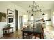 Charming dining room featuring a rustic table, modern chandelier, and views into the bright kitchen at 2067 Telfair Circle # A&B, Atlanta, GA 30324