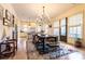 Open dining room with modern light fixtures, a view to the kitchen, and hardwood floors at 2067 Telfair Circle # A&B, Atlanta, GA 30324