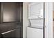 Compact stacked washer and dryer unit next to a dark-colored door at 2067 Telfair Circle # A&B, Atlanta, GA 30324