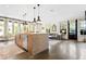 Open-concept living area and kitchen featuring a large island, hardwood floors, and natural light at 2067 Telfair Circle # A&B, Atlanta, GA 30324