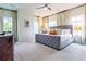 Spacious main bedroom featuring a tufted bed, plush carpeting, and large windows with stylish curtains at 2067 Telfair Circle # A&B, Atlanta, GA 30324