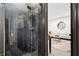 Stylish walk-in shower with dark tile and gold fixtures, connected to an adjacent living area at 2067 Telfair Circle # A&B, Atlanta, GA 30324