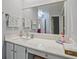 Bright bathroom boasts white cabinets, marble countertops, and a huge mirror reflecting the open doorway at 212 Abingdon Way, Atlanta, GA 30328