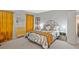 Comfortable bedroom featuring light gray walls, hardwood floors, and eye-catching orange curtains at 212 Abingdon Way, Atlanta, GA 30328
