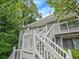 Charming two-story condo with light gray siding and white trim, nestled among lush greenery under a bright blue sky at 212 Abingdon Way, Atlanta, GA 30328