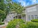 Two-story condo with light gray siding, complemented by white trim and vibrant landscaping, creates a welcoming facade at 212 Abingdon Way, Atlanta, GA 30328