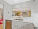 Bright kitchen with a pass-through to the living area, featuring white cabinets, stainless steel appliances, and sleek countertops at 212 Abingdon Way, Atlanta, GA 30328