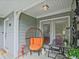 Cozy covered porch furnished with a unique egg chair and bistro set, perfect for relaxing outdoors at 212 Abingdon Way, Atlanta, GA 30328