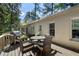 Outdoor deck featuring a grill, dining area, and a scenic view of the lush greenery at 414 E Wesley Ne Rd, Atlanta, GA 30305