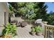 Outdoor deck featuring a grill, dining area, and a scenic view of the lush greenery at 414 E Wesley Ne Rd, Atlanta, GA 30305