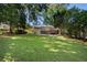 Spacious backyard featuring a well-maintained lawn, mature trees, and an elevated deck perfect for outdoor entertaining at 414 E Wesley Ne Rd, Atlanta, GA 30305