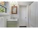 Traditional bathroom with marble countertop, green cabinets, and a framed mirror at 414 E Wesley Ne Rd, Atlanta, GA 30305