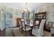 Elegant dining room with sophisticated wallpaper, a glass table, and stylish seating for formal meals at 414 E Wesley Ne Rd, Atlanta, GA 30305