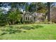 Charming cottage-style home with lush landscaping, inviting curb appeal, and a well-maintained front yard at 414 E Wesley Ne Rd, Atlanta, GA 30305