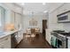Bright kitchen with stainless steel appliances, white cabinetry, hardwood floors, and an eat-in dining area at 414 E Wesley Ne Rd, Atlanta, GA 30305