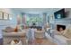 Bright living room featuring a fireplace, plush seating, large windows, and stylish decor accents at 414 E Wesley Ne Rd, Atlanta, GA 30305